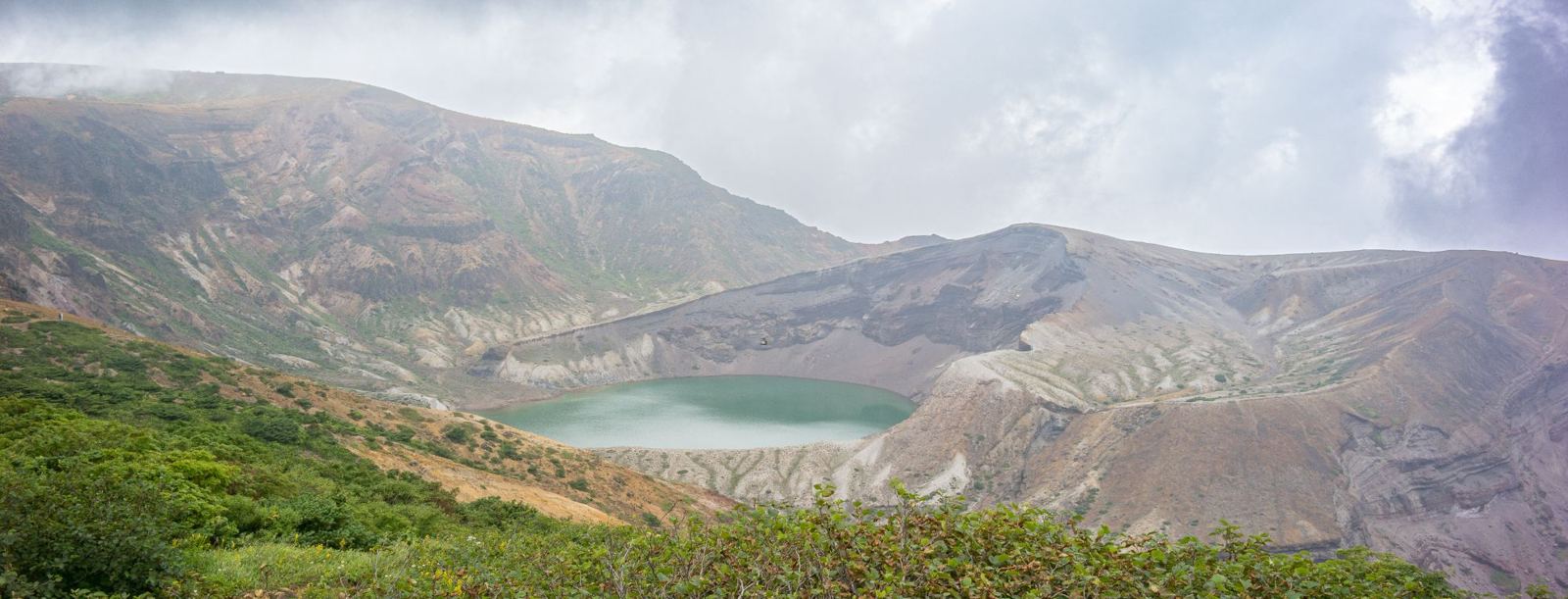 Okama crater lake on Mount Zaō under low cloud